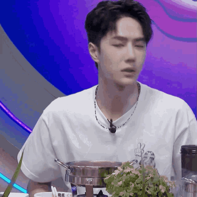 a man in a white shirt with a peace sign on his shirt