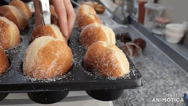 a bunch of muffins in a tray that says made in animatica on the bottom