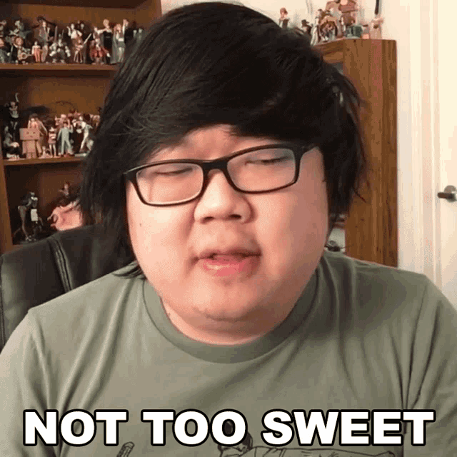 a man wearing glasses and a shirt that says " not too sweet "