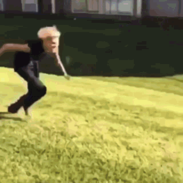a person is jumping in the air on a yellow field