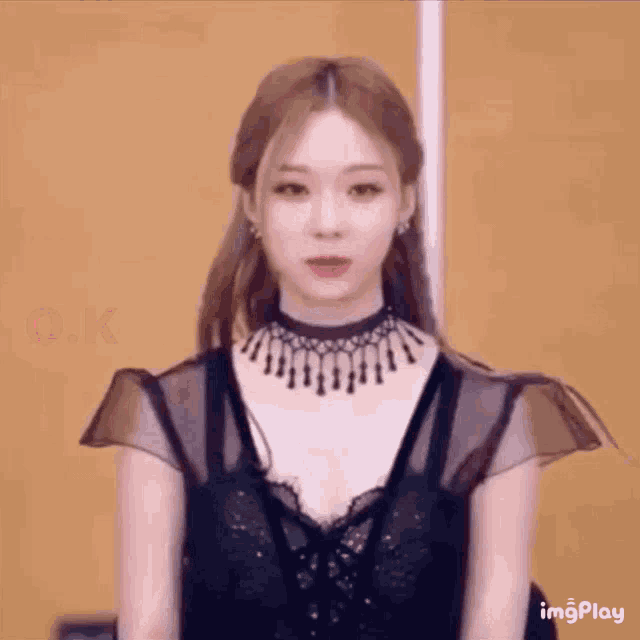a close up of a woman wearing a choker and a black top