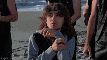 a group of men are standing on a beach and one of them has a tattoo that says m3