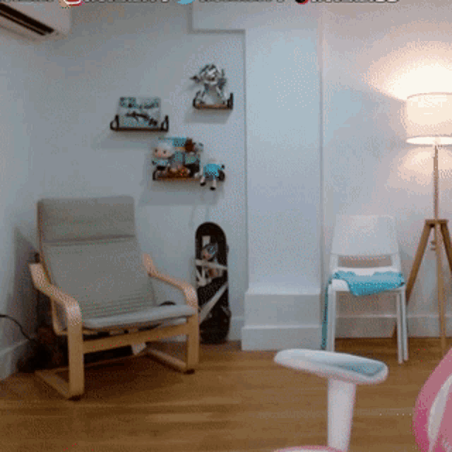 a room with a chair a lamp and a skateboard hanging on the wall