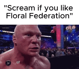 a man is screaming in front of a crowd while wearing a w logo on his chest