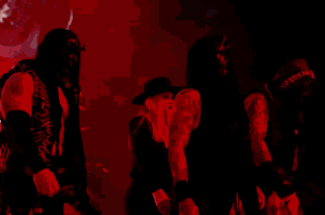 a woman in a black hat is standing next to a man in a black shirt that says ' slayer '