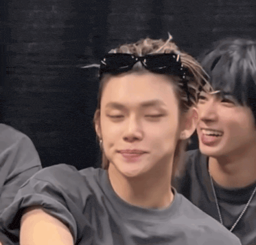 a man with sunglasses on his head is smiling