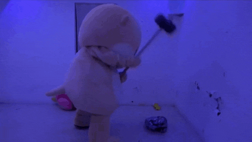 a squirrel mascot is standing in a room with a blue light behind it