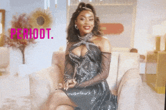 a woman in a black dress is sitting on a couch with the word period written in pink
