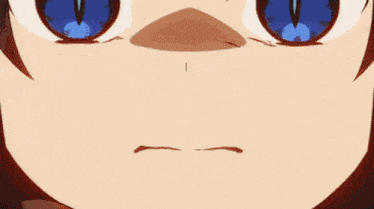a close up of a person 's face with blue eyes and an angry look on their face .