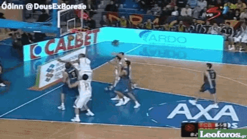 a basketball game is being played on a court with an advertisement for calbet
