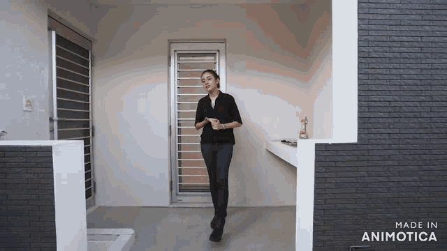 a woman is standing in front of a door that is made in animotica