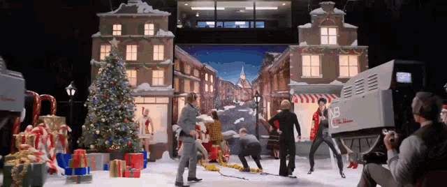 a group of people dancing in front of a camera that says nb