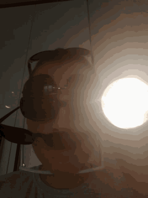 a person wearing sunglasses is taking a selfie