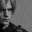 it is a black and white photo of a man 's face .