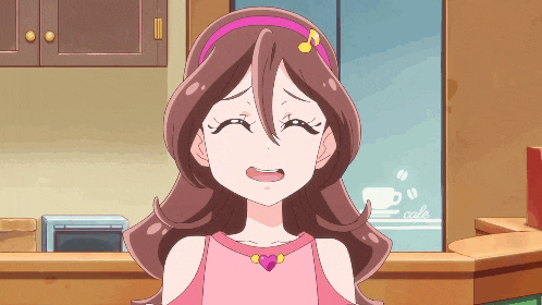 a girl in a pink dress is crying in front of a cafe