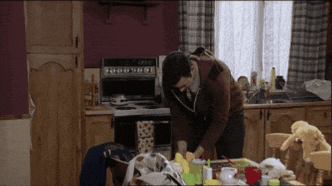 a man is standing in a kitchen with a stove that says 000