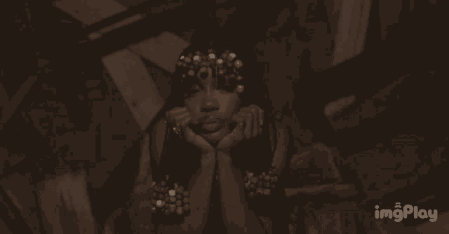 a gif of a woman with a crown of flowers on her head is displayed on imgplay