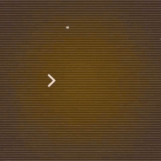 a brown striped background with a white arrow pointing to the left .