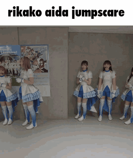 a group of girls standing in front of a poster that says lovelive on it