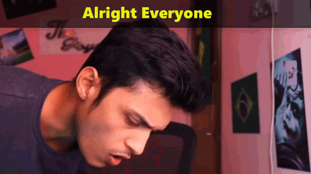 a man in a room with the words alright everyone on the bottom