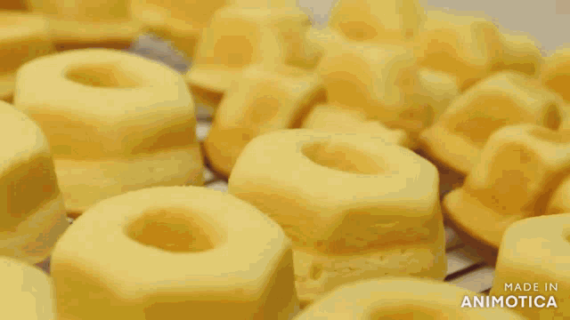 a bunch of cakes in the shape of a wrench are on a cooling rack made in animatica