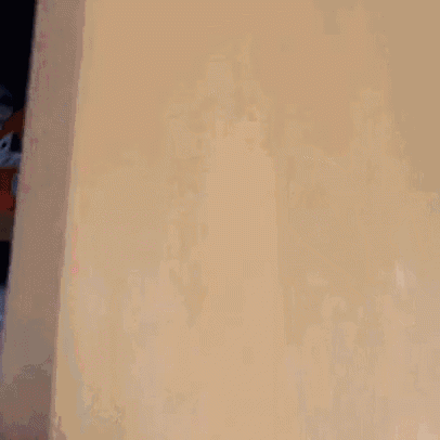 a red laundry detergent bottle sits on a shelf in a closet