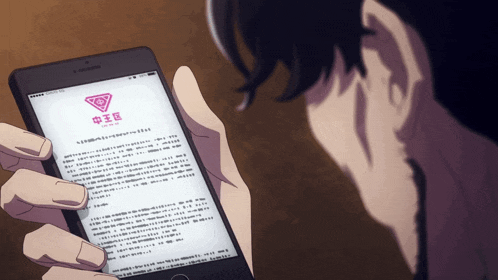 a person is holding a phone with chinese writing on it