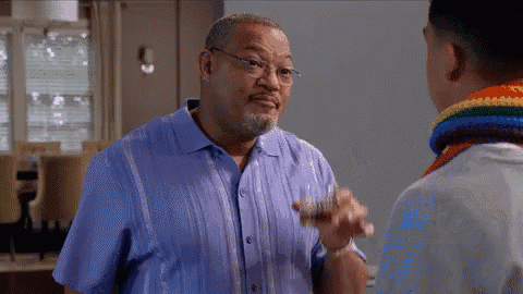 a man in a blue shirt is talking to a boy in a rainbow scarf