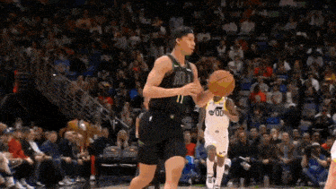 a basketball player is dribbling a basketball during a game .