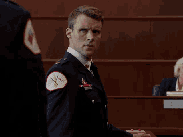 a man in a military uniform has a patch on his shoulder that says ' chicago fire department '