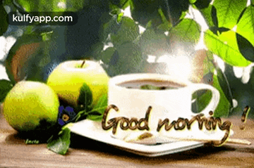 a cup of coffee and apples on a plate with the words `` good morning '' written on it