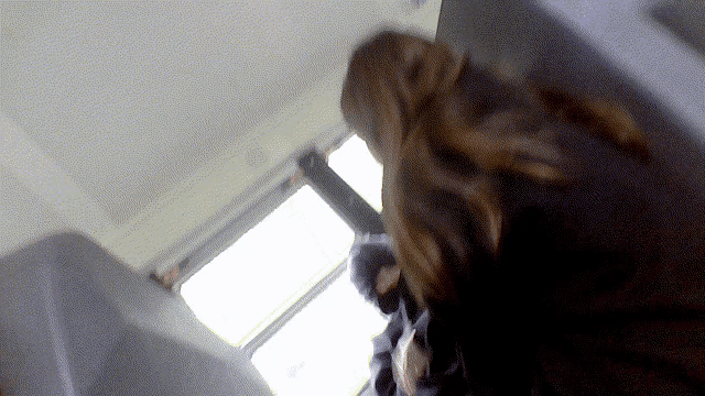 a blurry picture of a person sitting in a room with a window