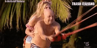 a man is being pulled by a woman in a bikini on a rope .