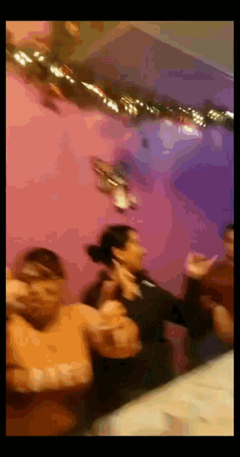 a blurry picture of a group of people dancing in a room