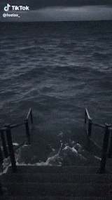 a tiktok video shows a man holding a knife in front of a body of water ..