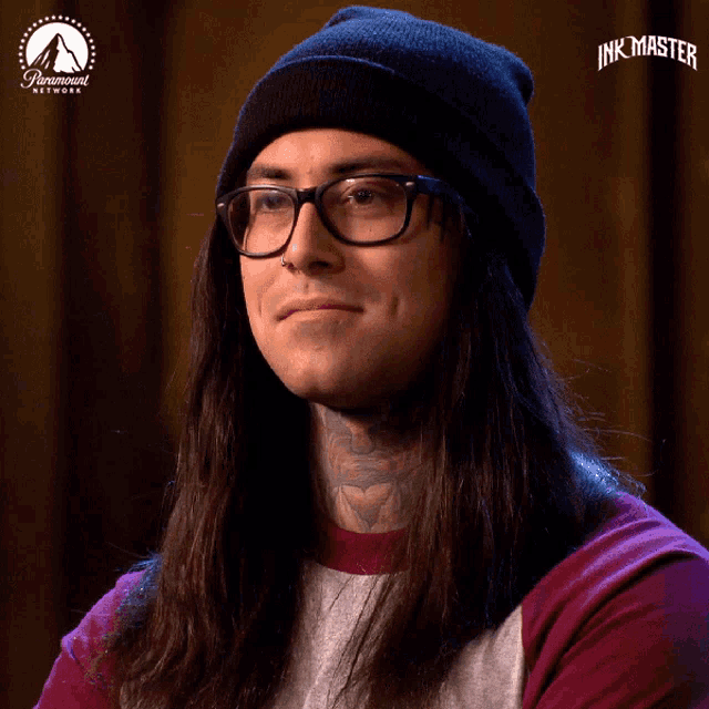 a man with long hair wearing glasses and a black beanie is on paramount network 's show ink master
