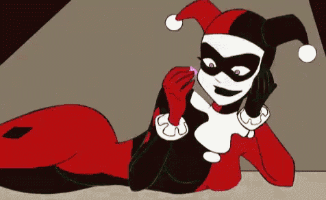 a cartoon of harley quinn laying down talking on a phone .