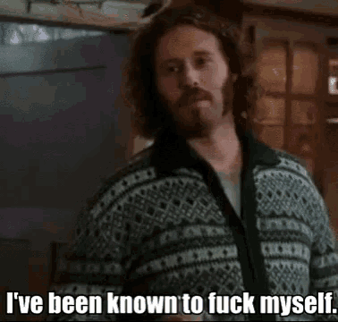 a man with a beard is wearing a green and white sweater and says i 've been known to fuck myself
