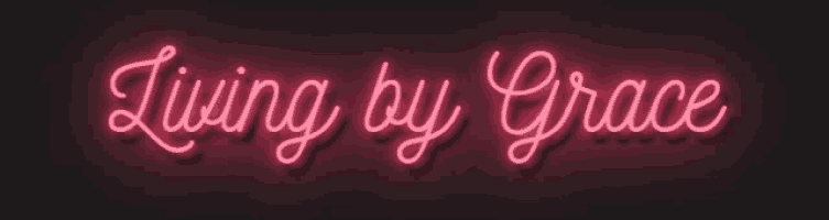 a neon sign that reads living by grace on a dark background