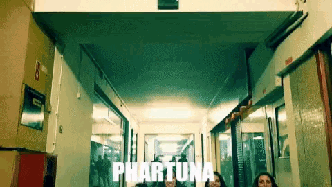 a group of people standing in a hallway with the word phartuna on the bottom right