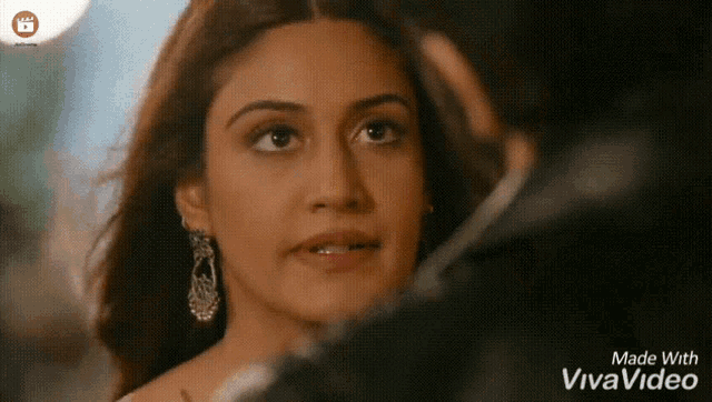 a woman looking at a man with the words made with vivavideo below her