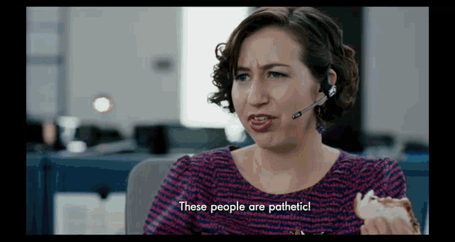 a woman wearing a headset is eating a donut and saying these people are pathetic