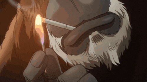 a close up of a person lighting a cigarette