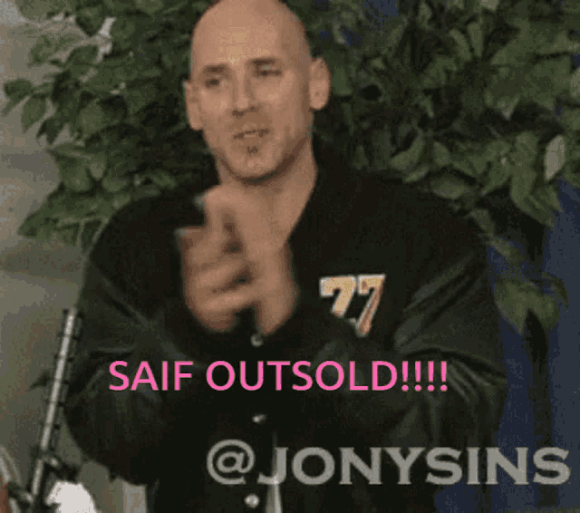 a bald man applauds in front of a sign that says " saif outsold !!! "