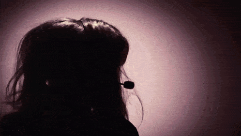 a silhouette of a woman wearing a microphone