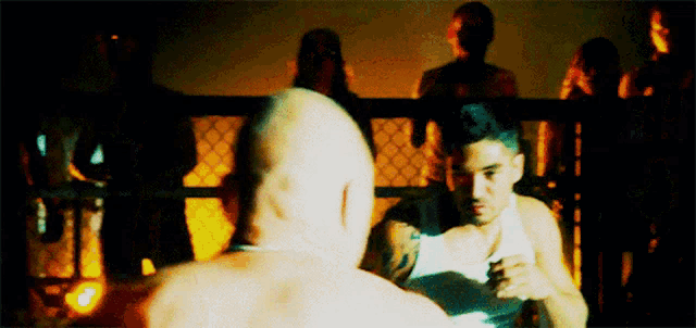 a man in a boxing ring with a crowd watching