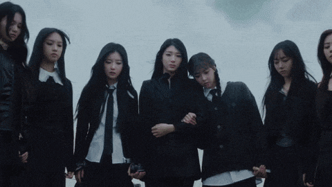 a group of girls are standing next to each other in a row