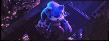 sonic the hedgehog is flying through the air with a blue light coming out of his eyes .