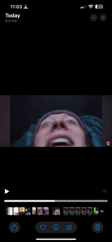 a phone screen shows a video of a man with his mouth open and the time of 11:03