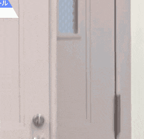 a young man is peeking out from behind a door and smiling .